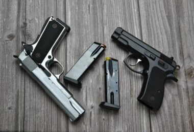 stock-photo-still-life-black-silver-handgun-cartridge-magazine-dummy-bullet-old